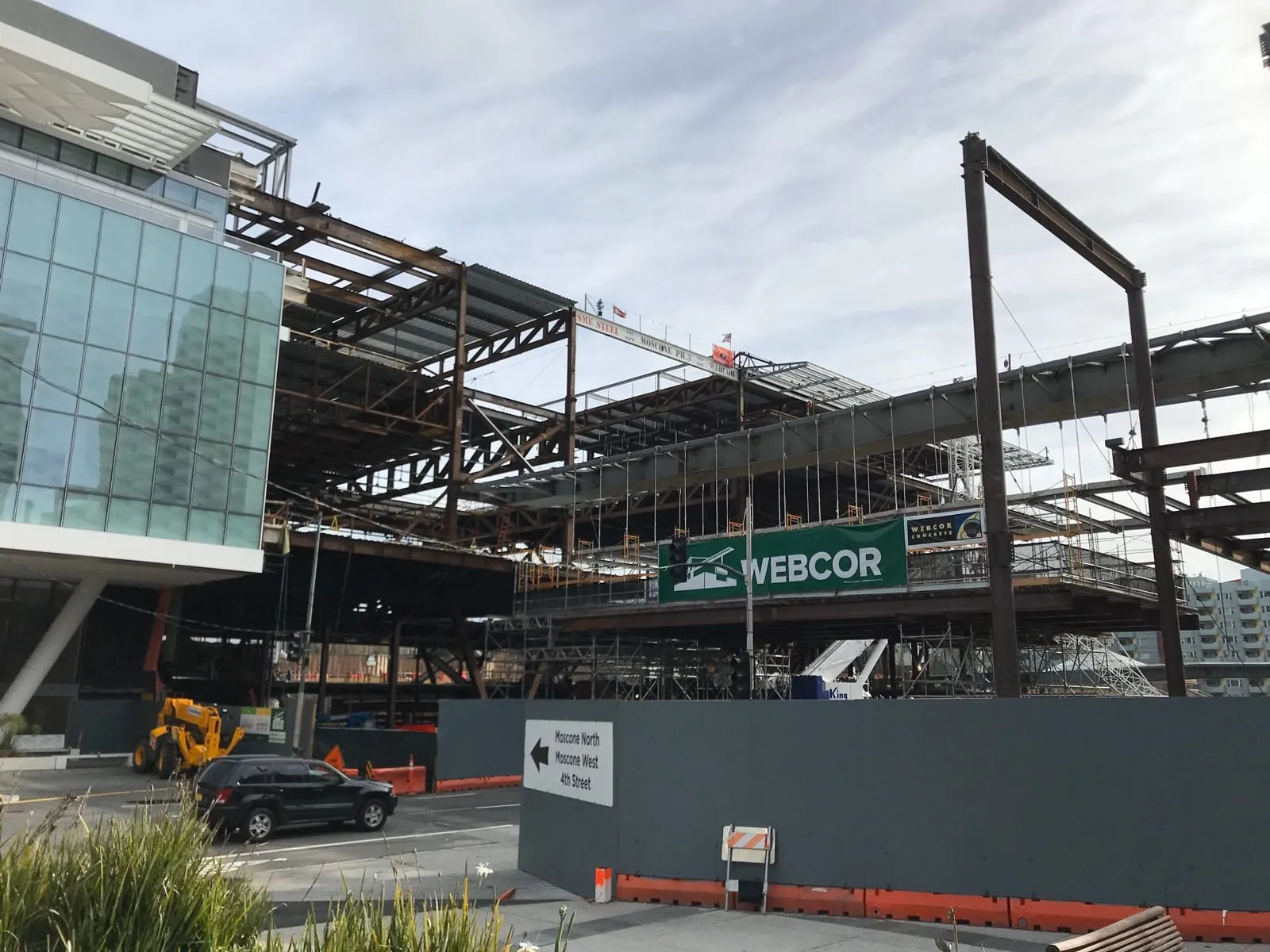 Structural steel rising behind a Webcor banner at Moscone Center