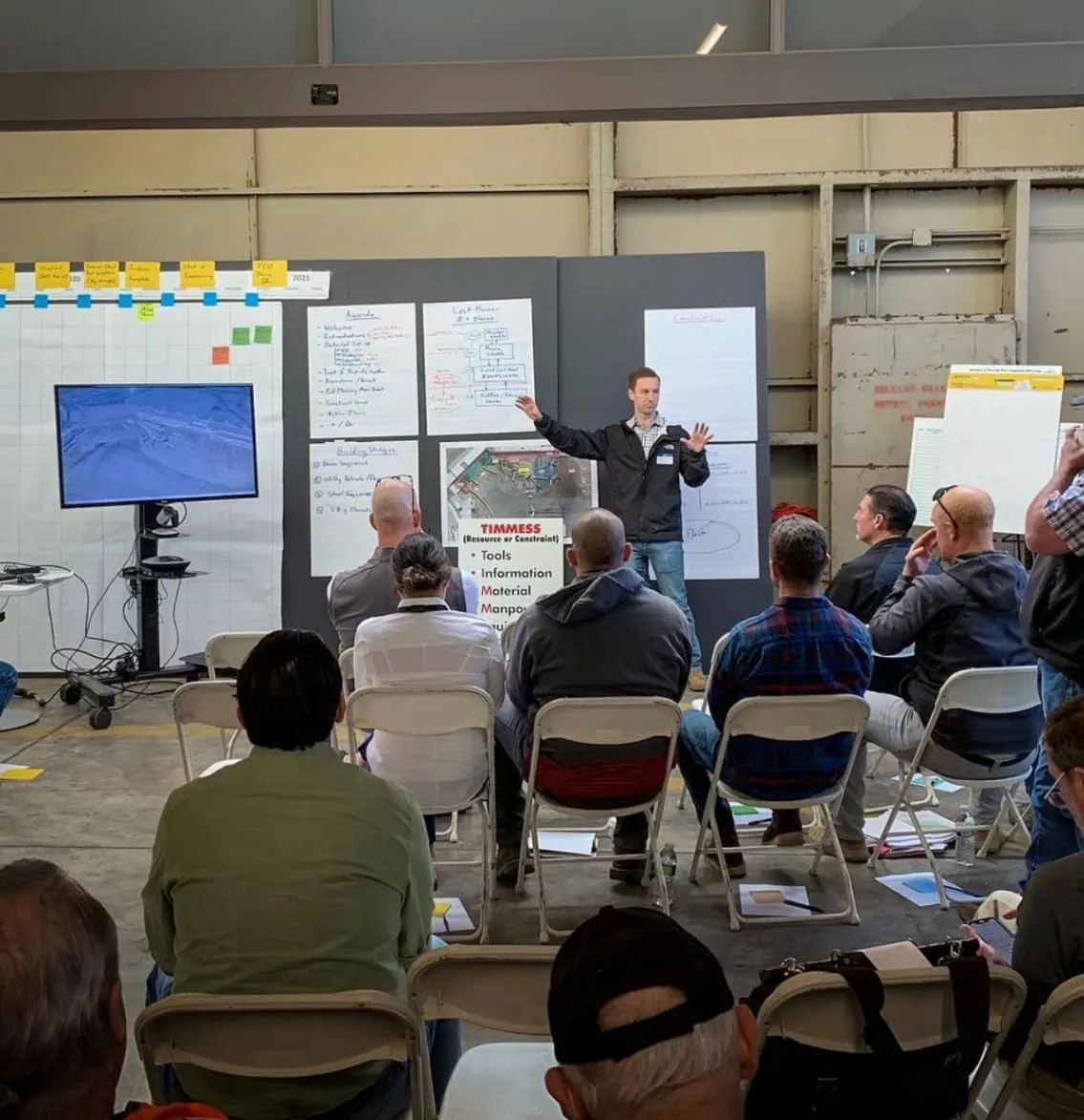 Chris presenting at a planning wall to a room of builders