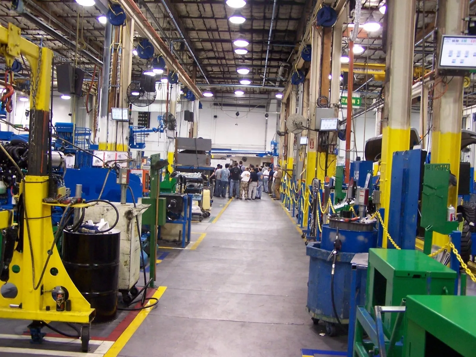 An assembly line with stations, tool reels and status screens