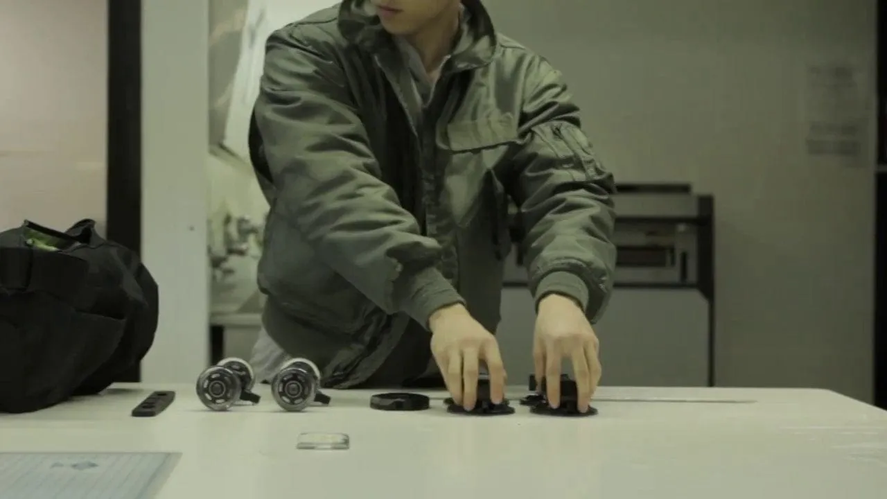 Hands snapping modular camera mounts together on a table